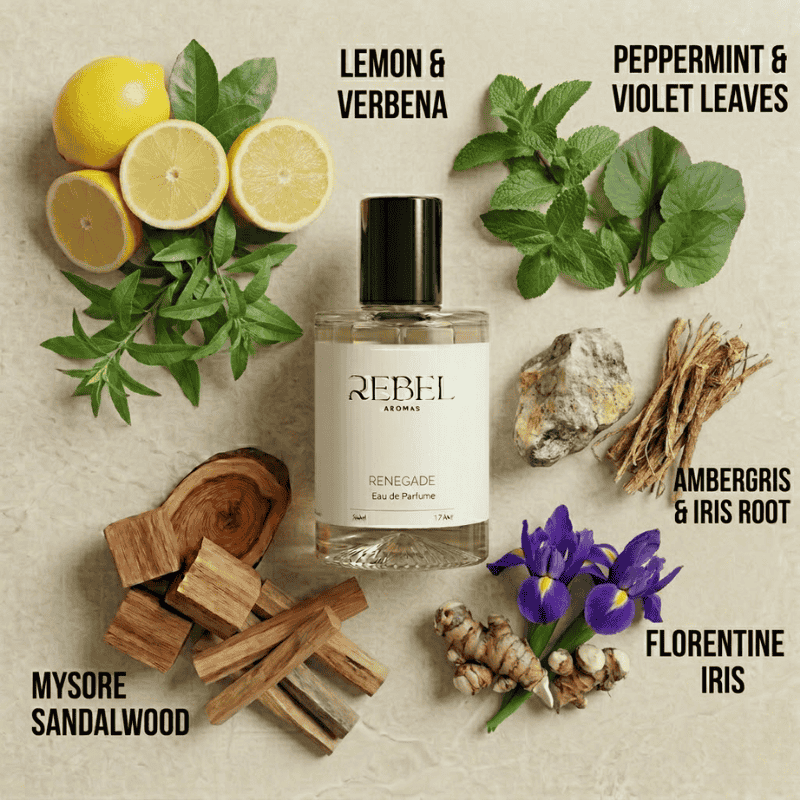 Perfume bottle labeled 'REBEL' surrounded by lemons, leaves, and other natural elements on a textured background.