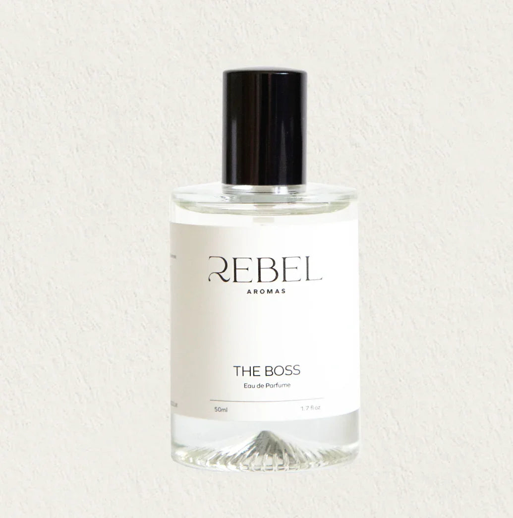 Perfume bottle labeled 'The Boss inspired' by Rebel Aromas on a light background