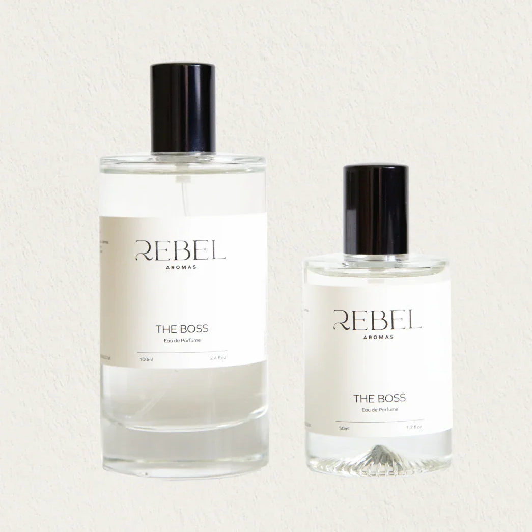 Two bottles of Rebel Aromas 'The Boss' perfume on a light background