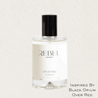Perfume bottle labeled 'REBEL Aromas Opium Red' on a light background