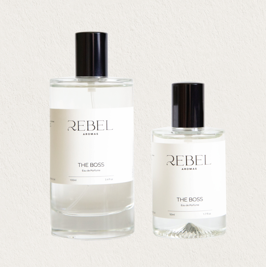 Two bottles of Rebel Aromas 'The Boss' perfume on a light background