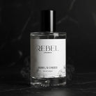 Perfume bottle labeled 'Rebel Aromas Rebel's Creed' on a dark background